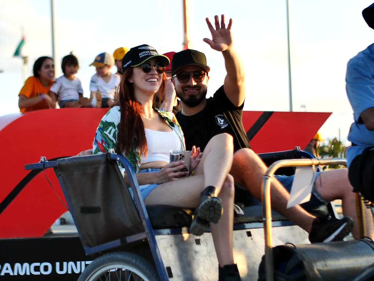 Race fans waving from a Kween Cab pedicab at Circuit of the Americas during Formula 1 weekend