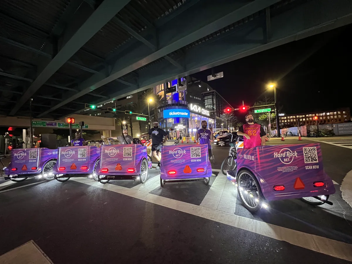 Lit Hard Rock Bet Kween Cab fleet outside the Kia Center in Orlando at night
