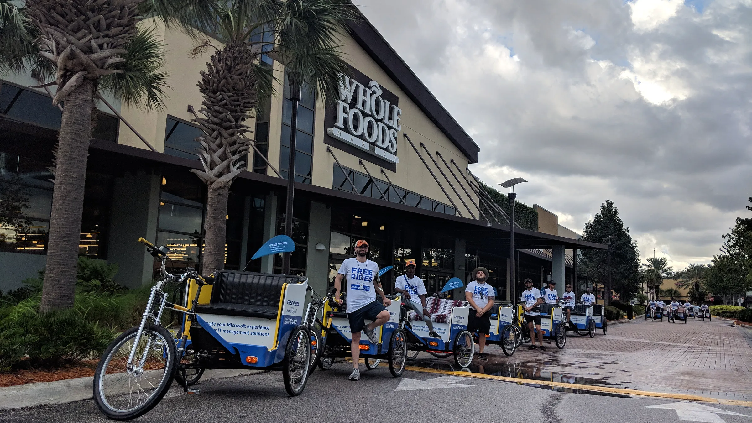 Kween Cab crew and pedicab fleet lined up downtown