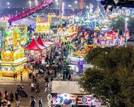 Crowds on the Houston rodeo carnival midway at night