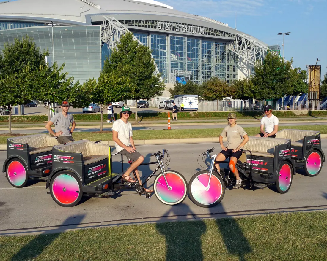 Branded pedicab fleet outside a Dallas stadium