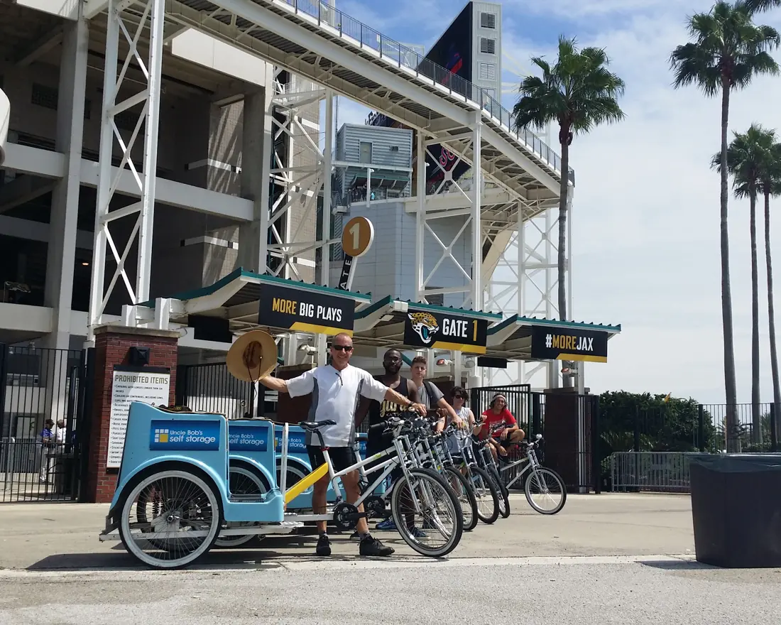 Branded pedicabs staged at a football stadium gate
