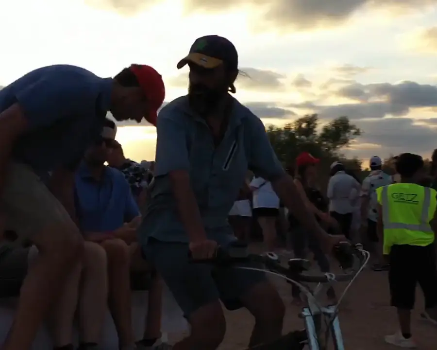 Driver and riders at sunset after a race