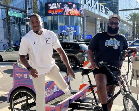 Hard Rock Bet driver and rider outside the Kia Center in downtown Orlando