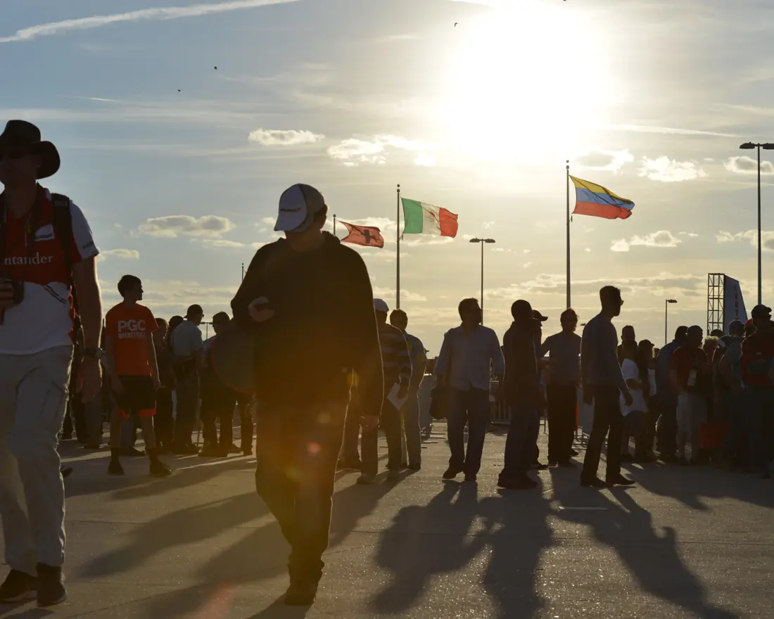 Race-day crowd walking at golden hour