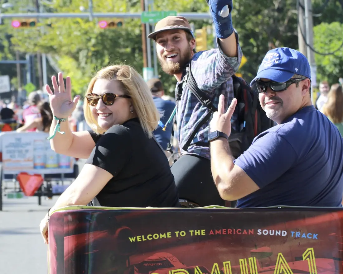 Riders in a Formula 1 wrapped pedicab in Austin