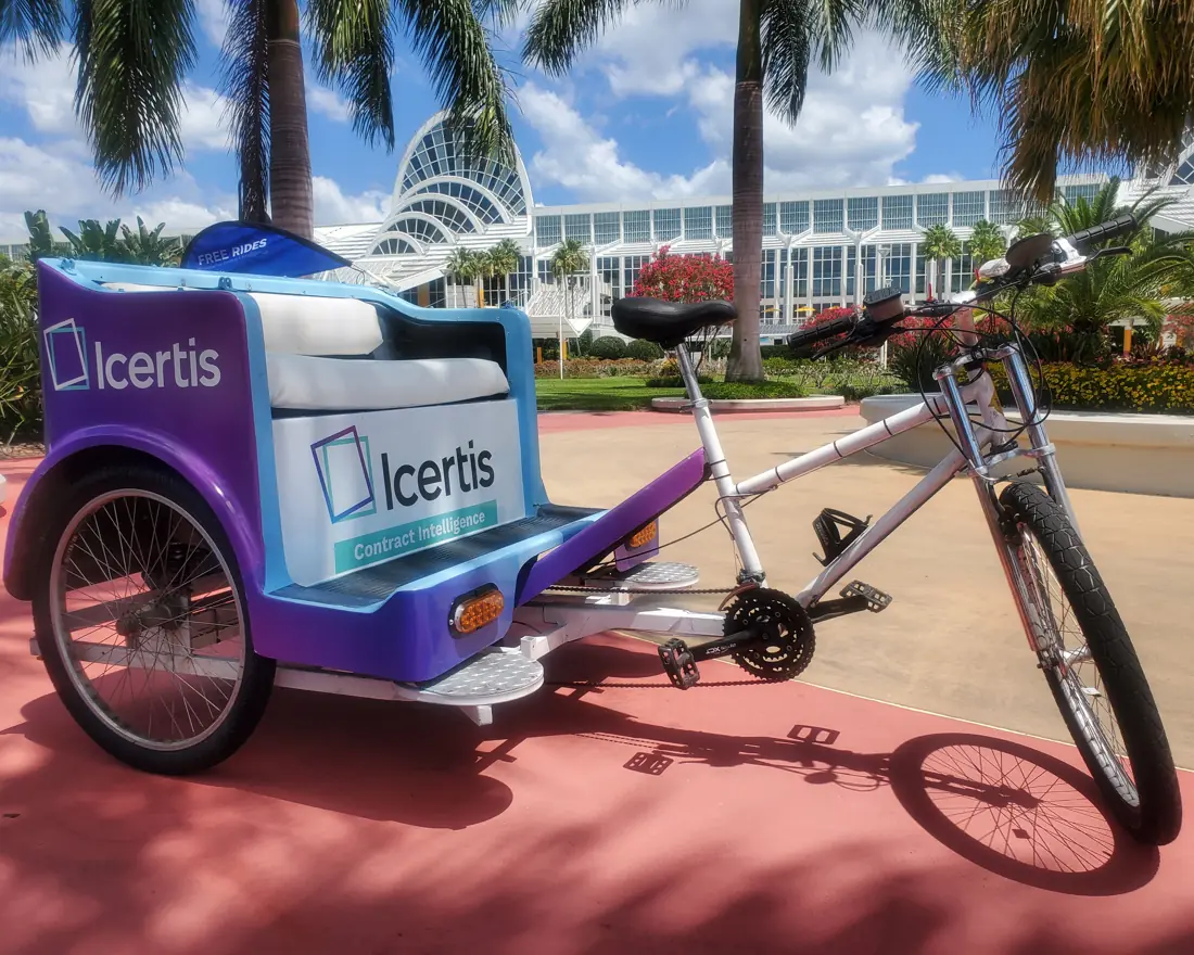 Single Icertis pedicab parked on International Drive