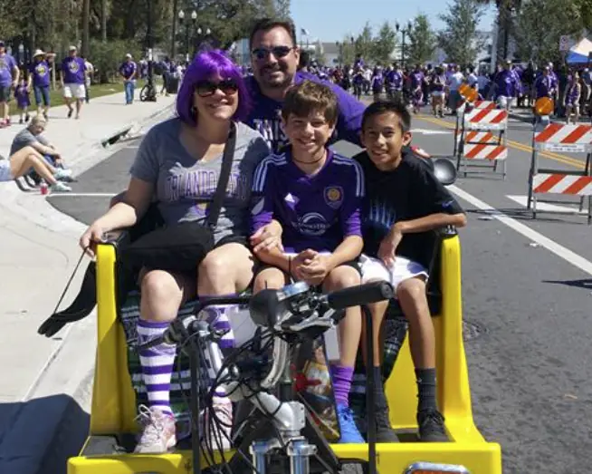 Soccer fans riding a pedicab on match day
