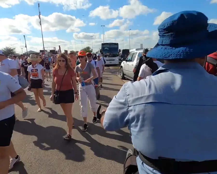 Race fans walking past a Kween Cab pedicab at Circuit of the Americas