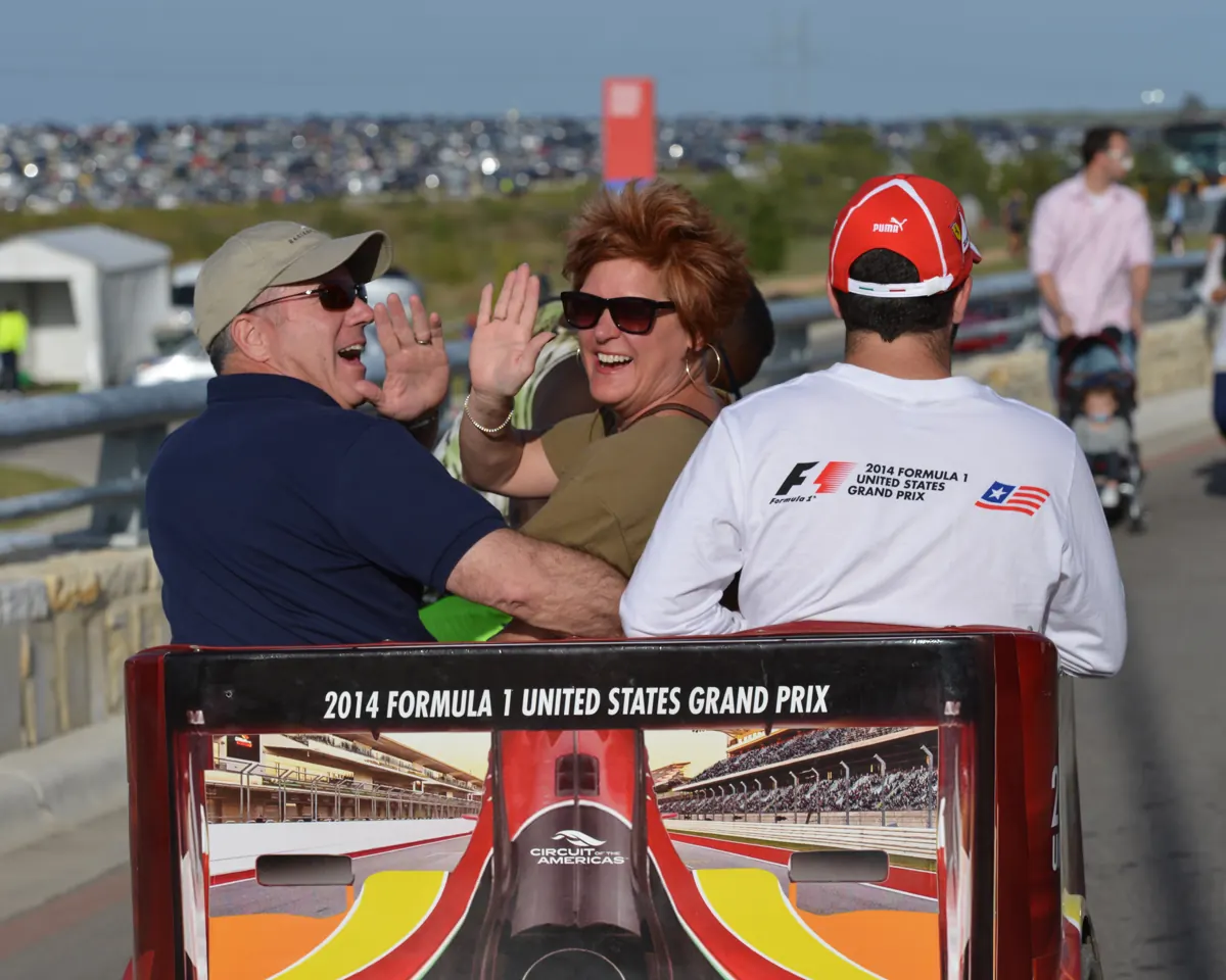 Race fans riding a Kween Cab pedicab at Circuit of the Americas